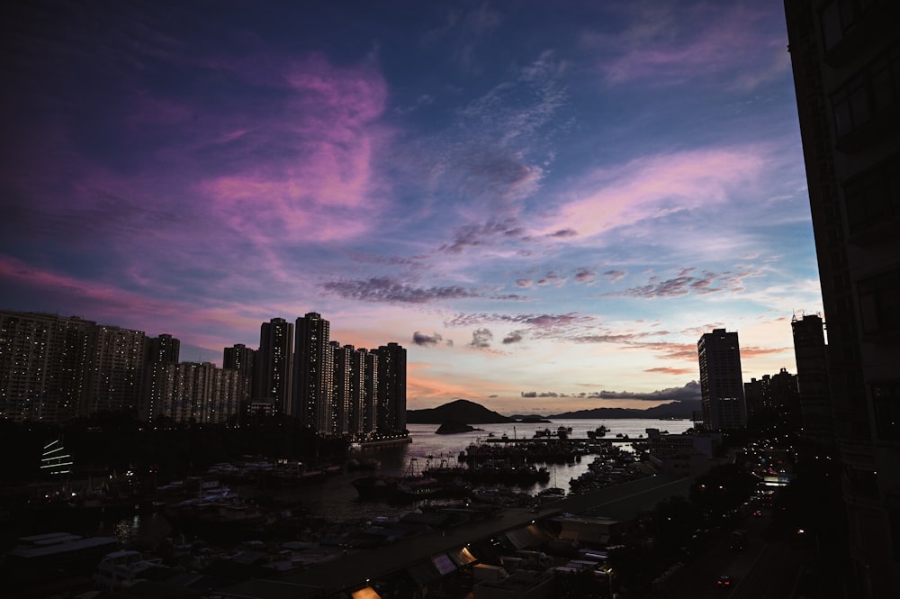 city skyline under purple and orange sky