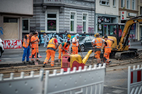 Road crew in orange hi-vis gathered on site