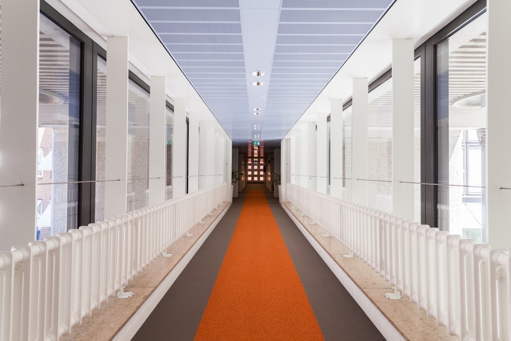 white and brown hallway with white metal railings