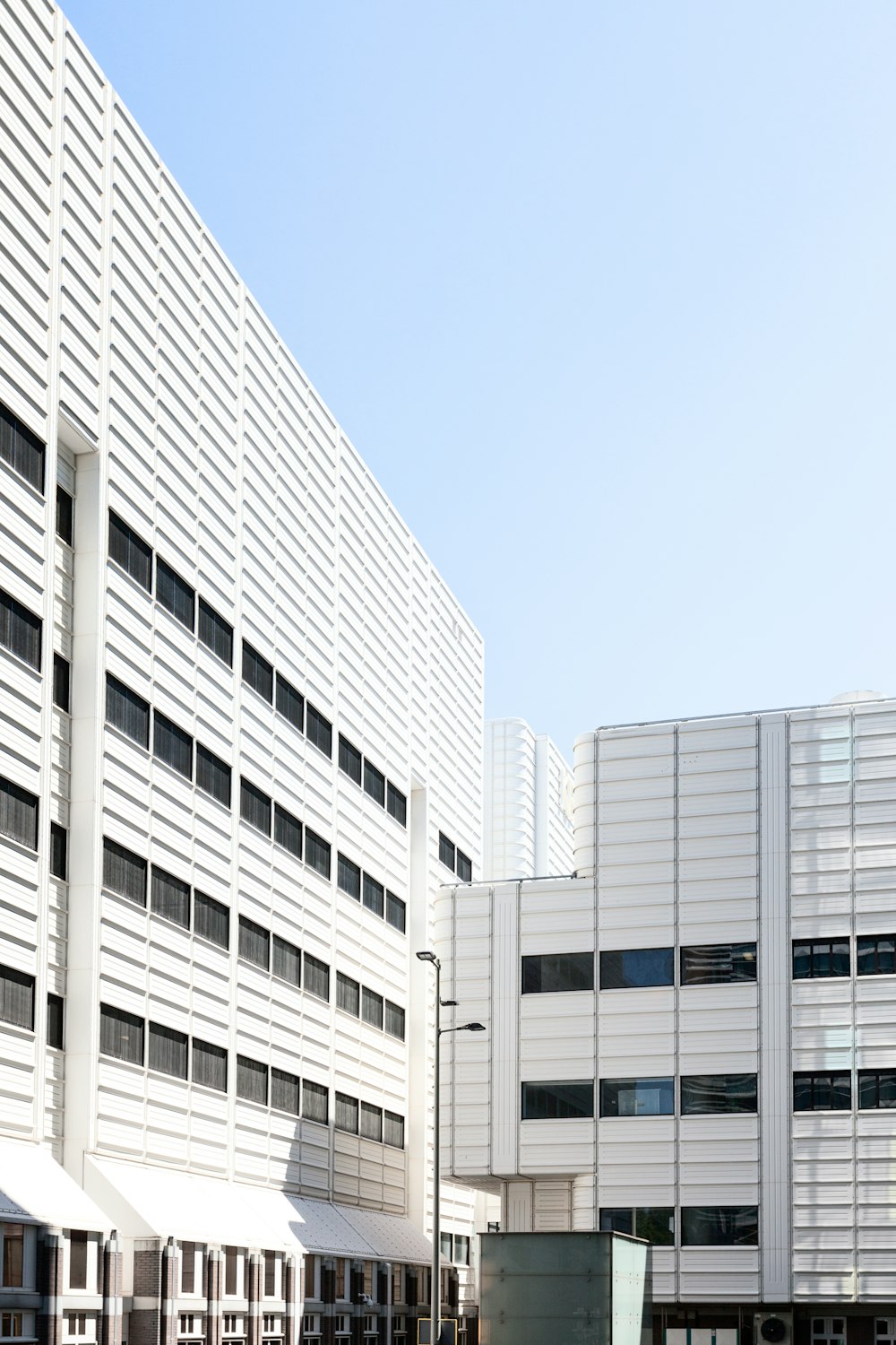 a large white building sitting next to a parking lot