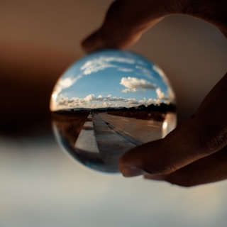 person holding clear glass ball