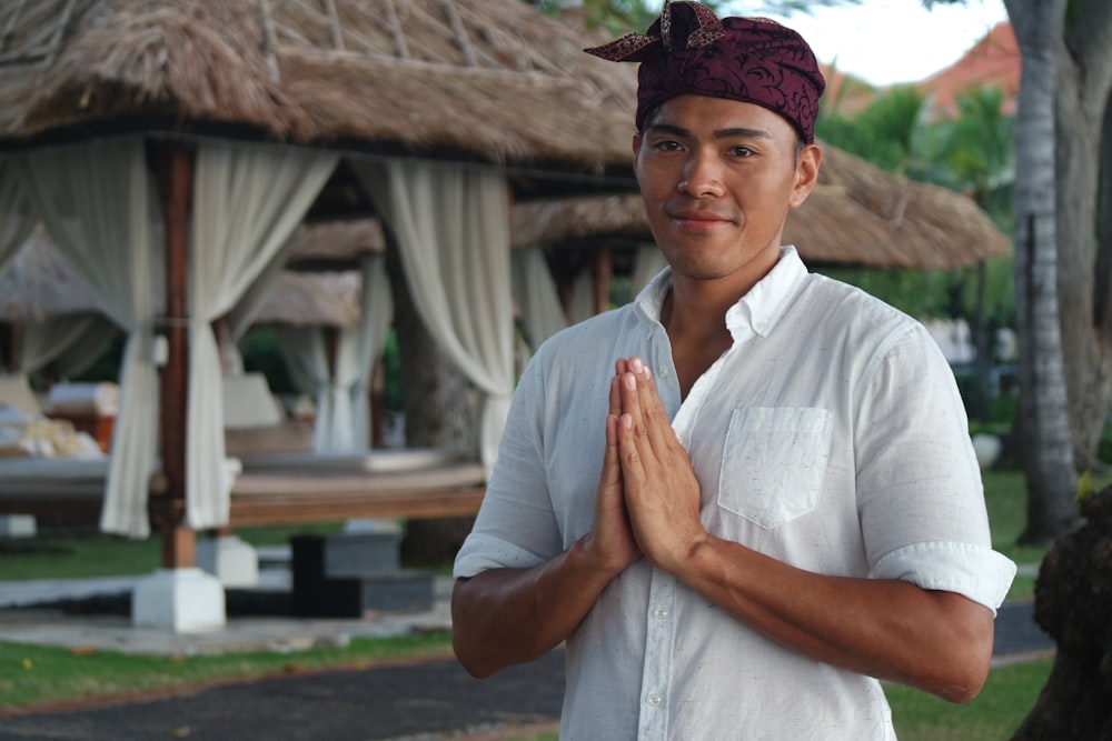 man in white polo shirt and red cap