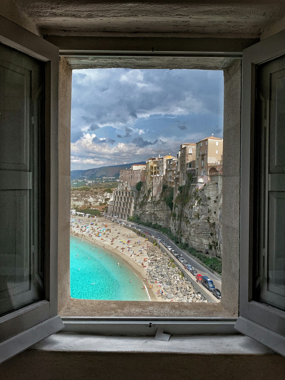 white framed glass window showing city buildings and trees during daytime