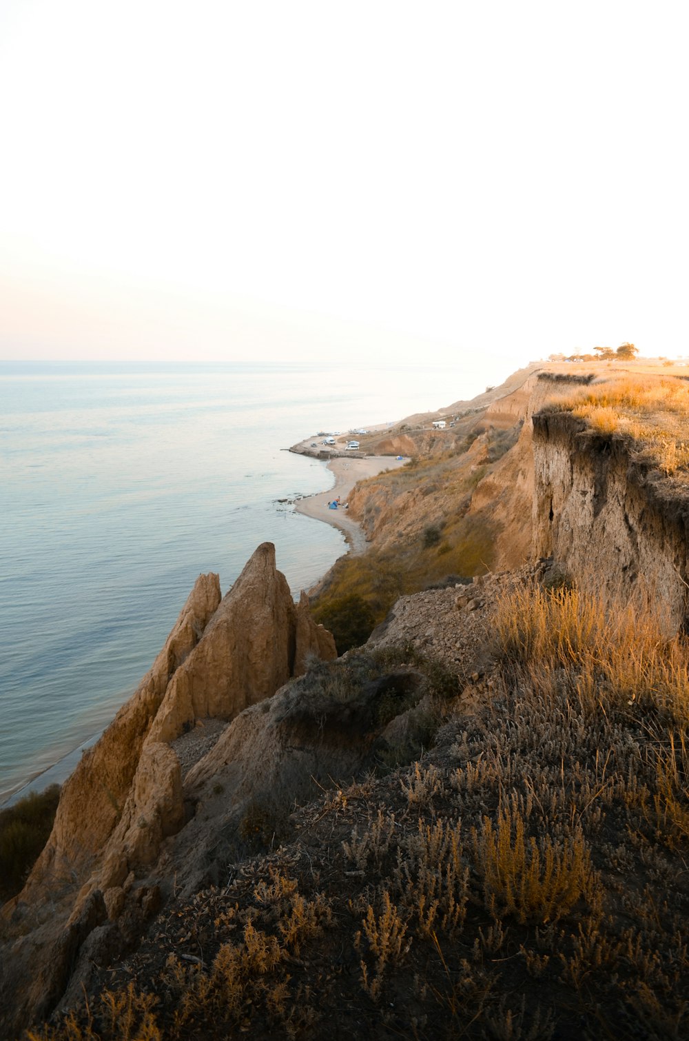 brown rock formation near body of water during daytime