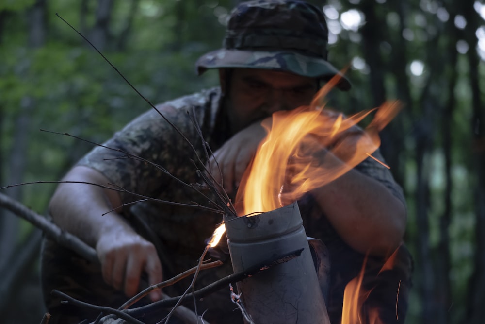 man in black and white camouflage jacket holding fire