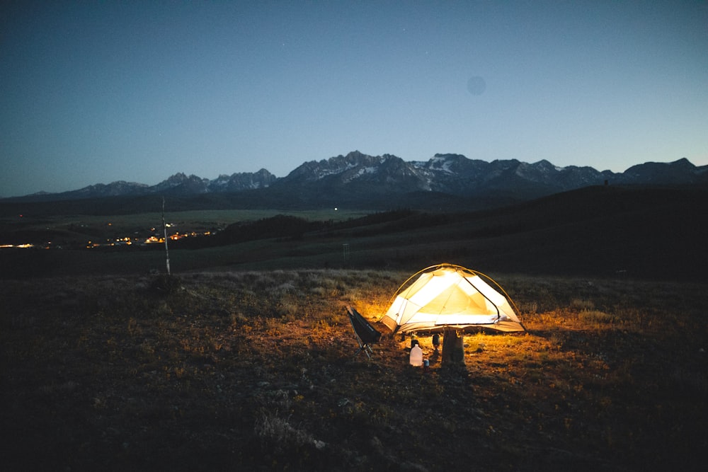 white tent on brown grass field during night time