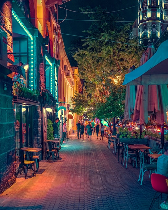 people sitting on brown wooden chairs during nighttime