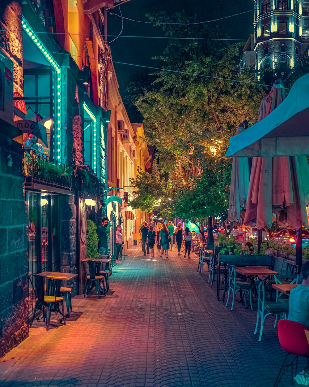 people sitting on brown wooden chairs during nighttime