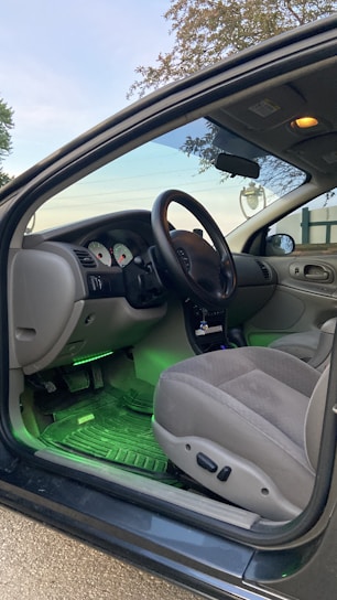 Display of various automotive accessories including steering wheels, seat covers, and floor mats