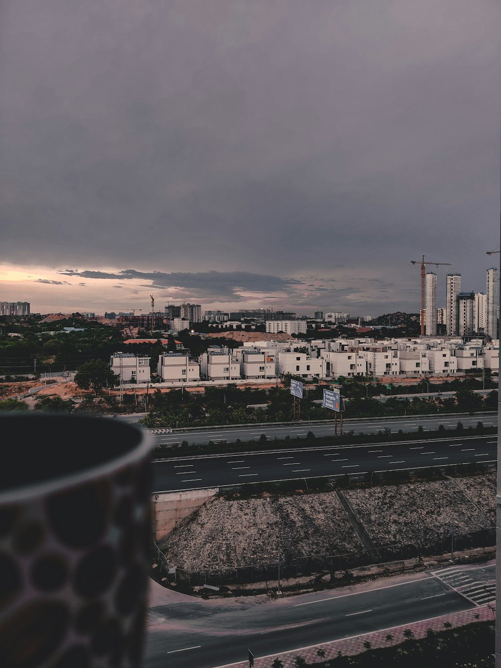 city with high rise buildings under gray sky during daytime