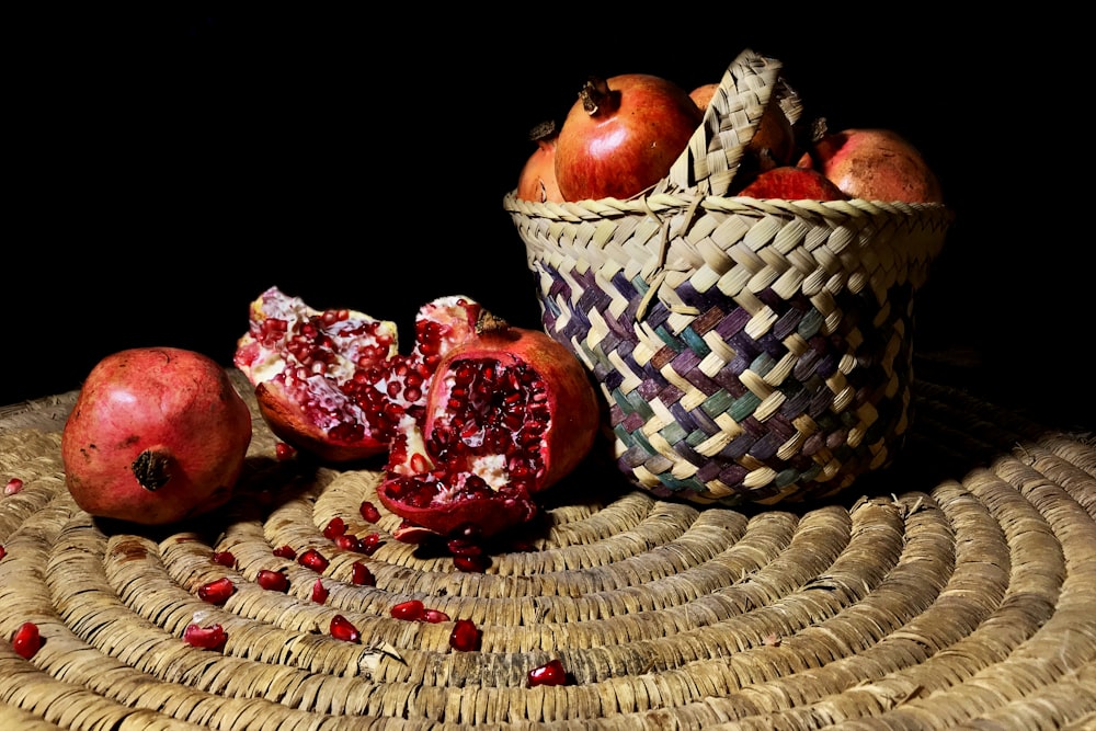 red apple fruits on brown woven basket