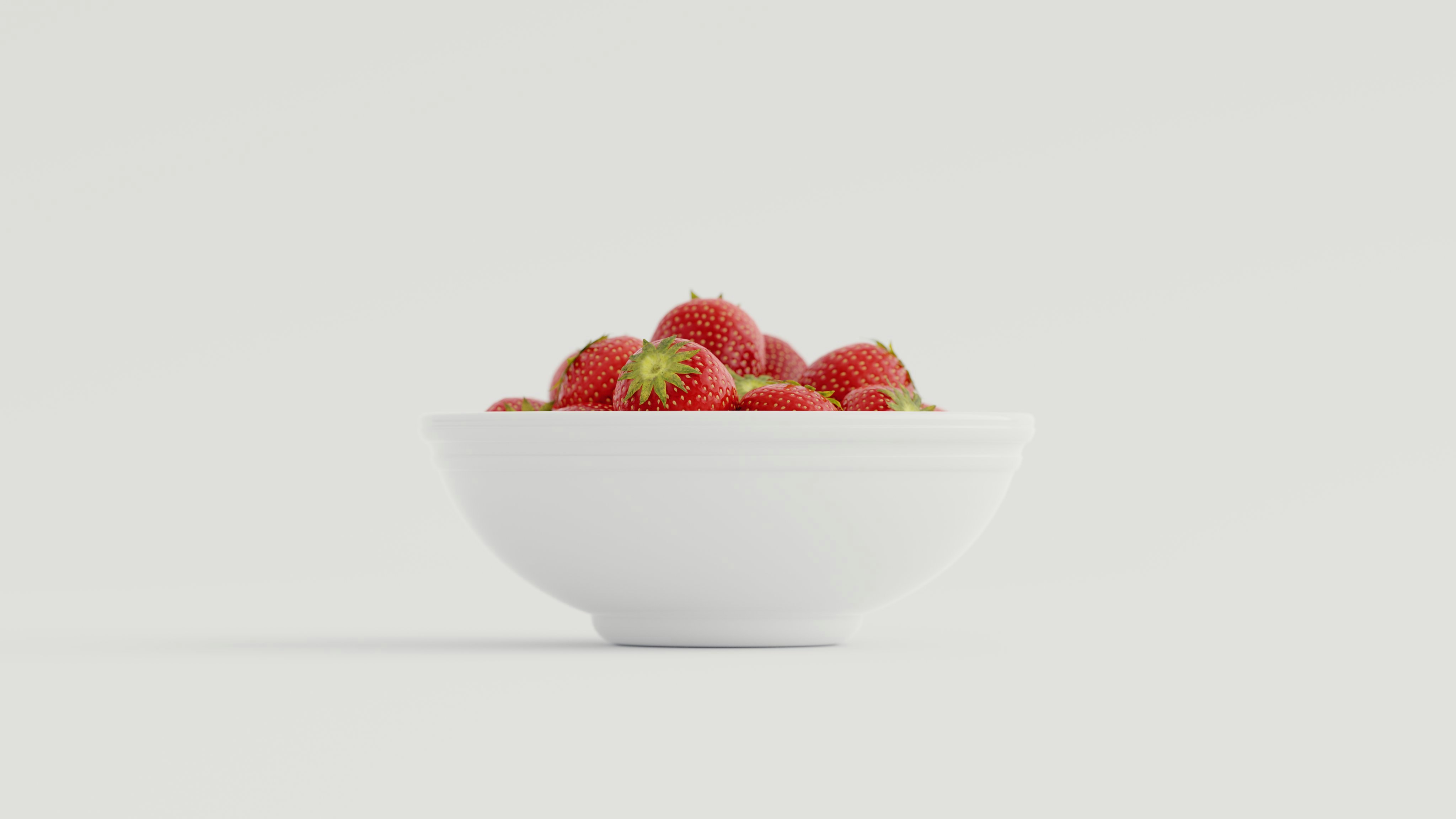 strawberries in white ceramic bowl