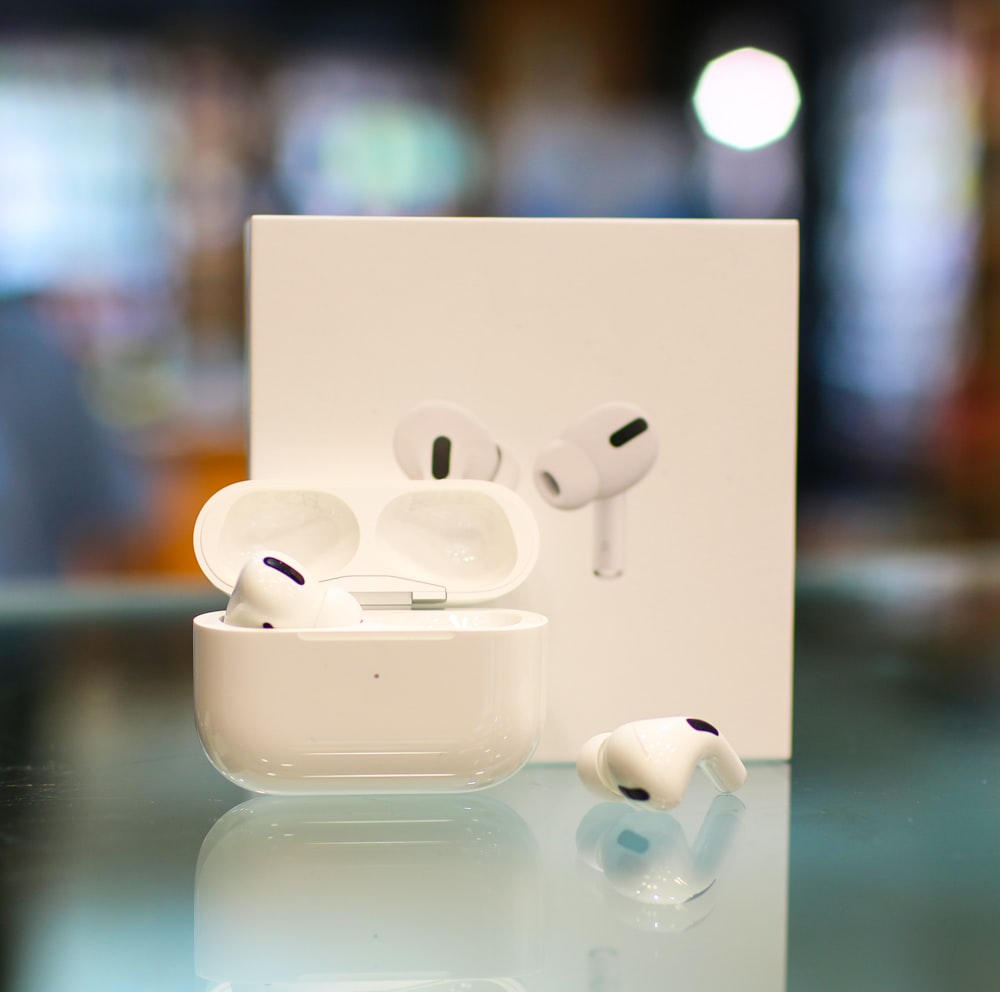 white apple earpods on white surface