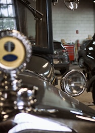 A vintage car being serviced in a workshop.
