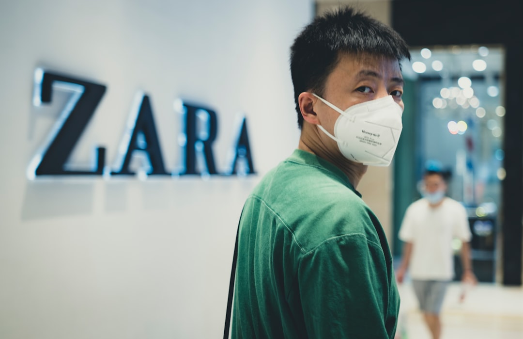 man in green crew neck shirt wearing white mask