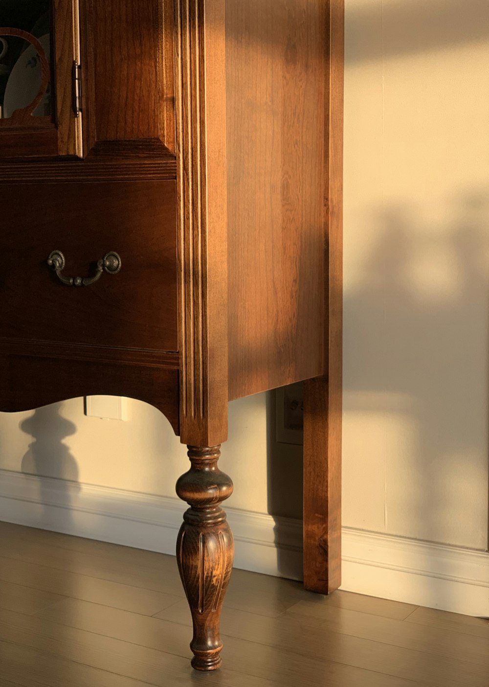 brown wooden drawer beside white wall