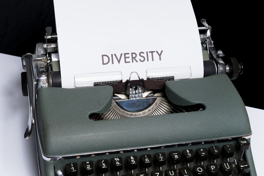 green and white typewriter on white table