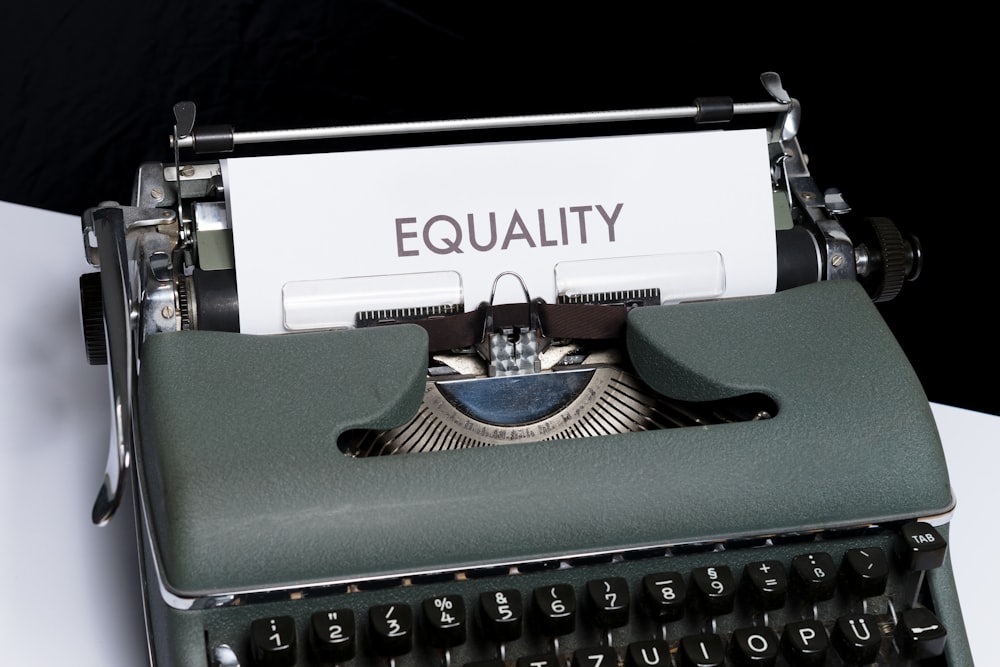 a typewriter with a paper that reads equality