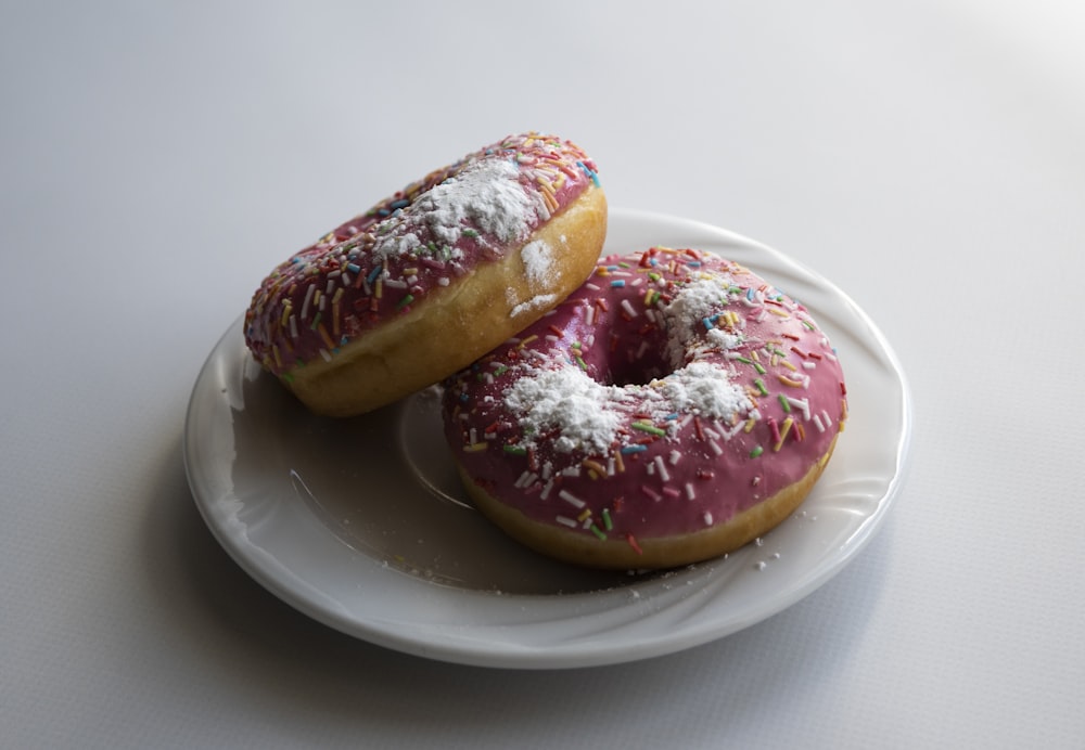 doughnut with sprinkles on white ceramic plate