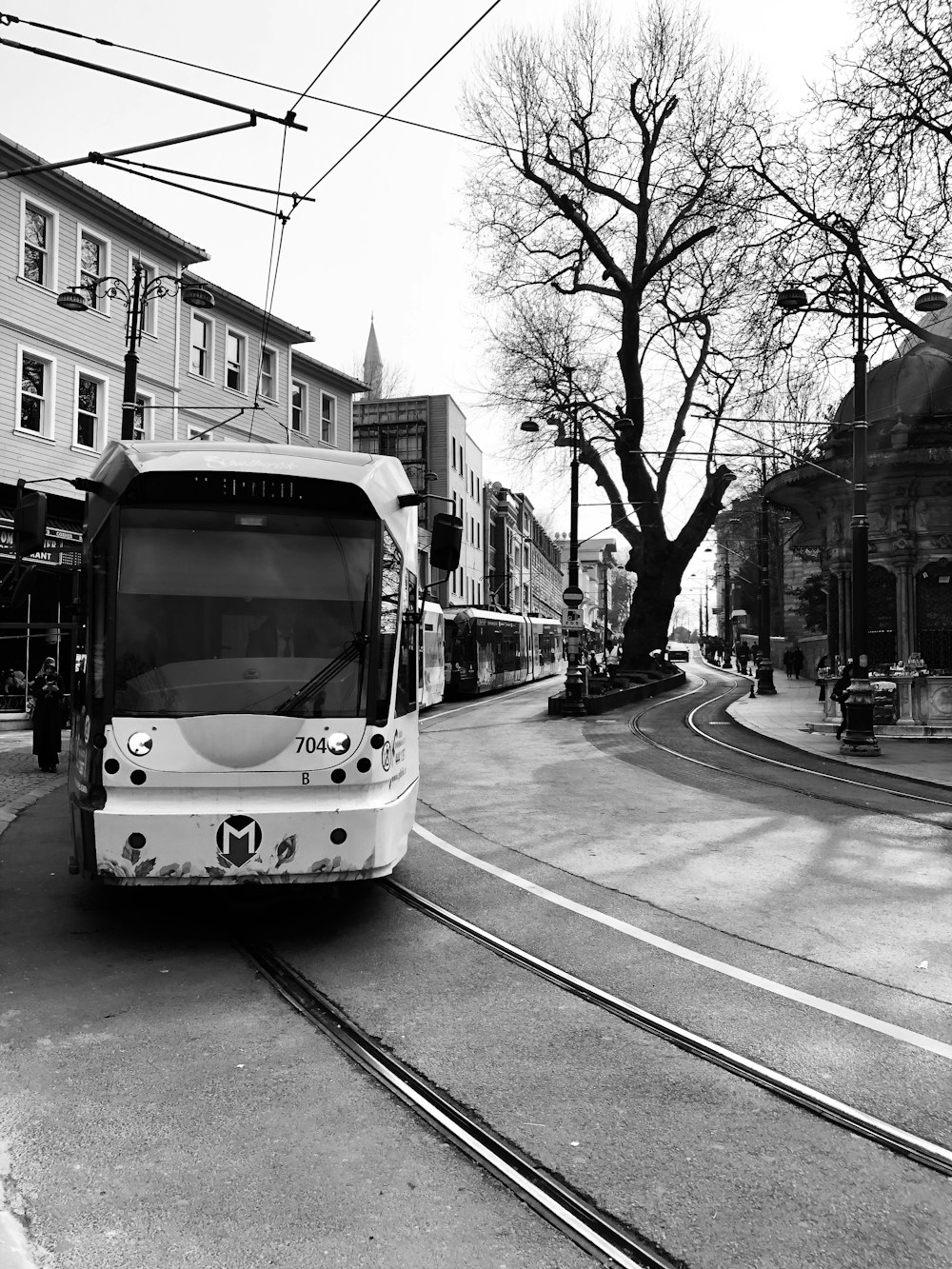 grayscale photo of tram on road