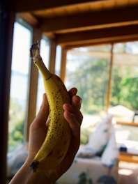 person holding yellow banana fruit