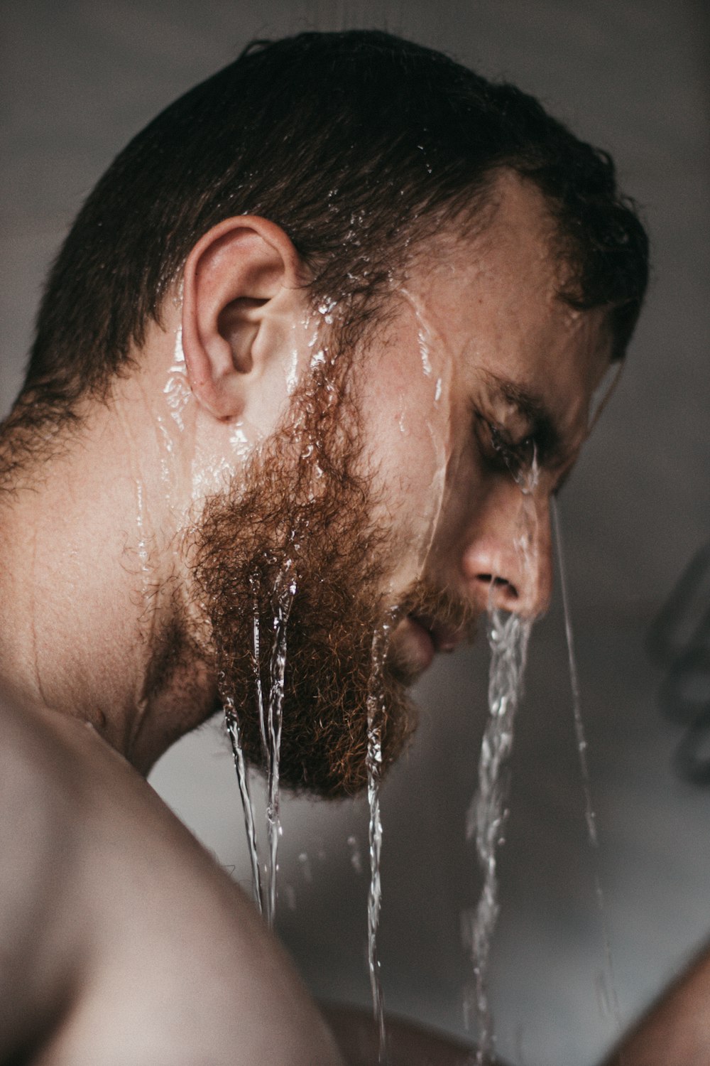 man with water splash on his face