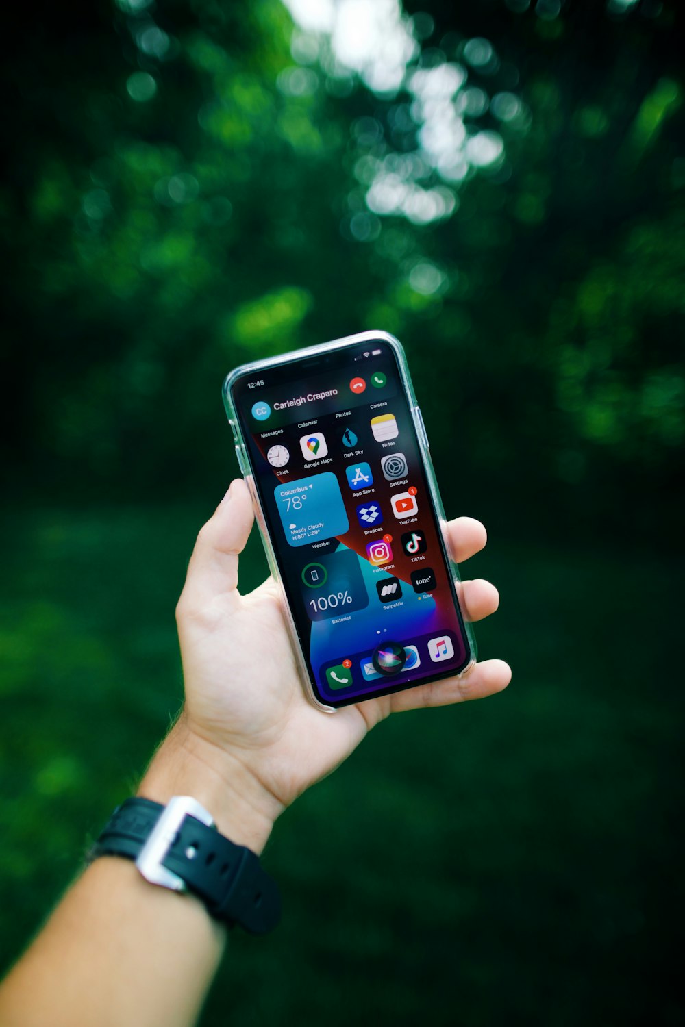 person holding black iphone 4