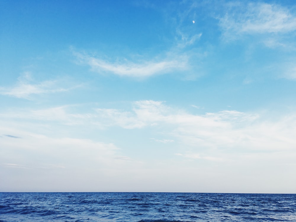 blue ocean under blue sky during daytime