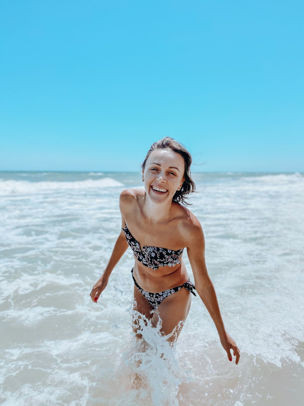 woman in black and white bikini on beach during daytime