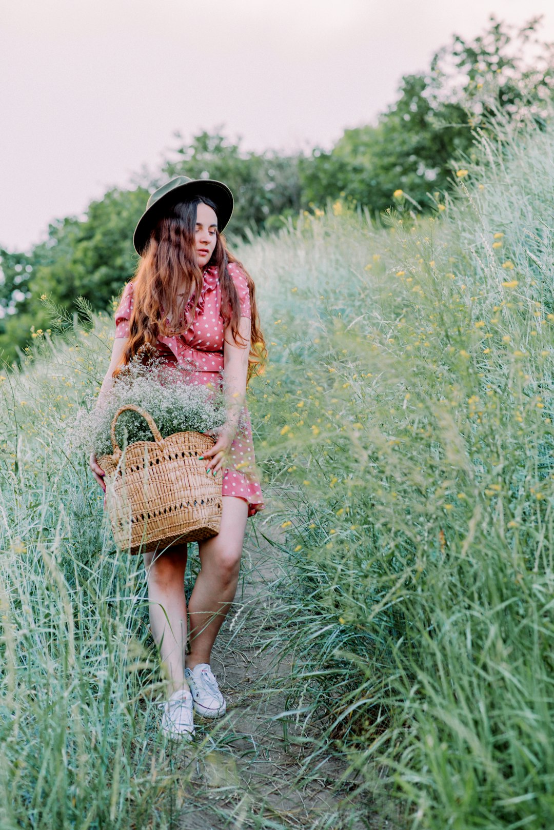 woman in brown dress holding brown woven basket