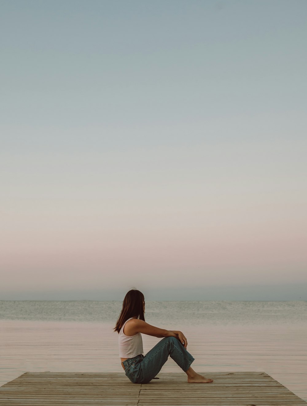 woman in black dress standing on beach during daytime