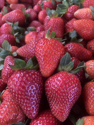 A close-up of fresh, vibrant fruits being carefully inspected in a production facility.