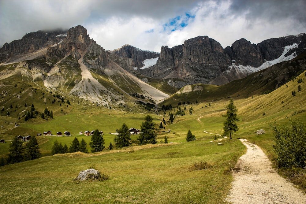 green grass field near mountain during daytime