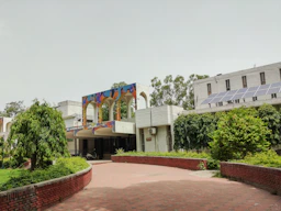 white concrete building with green plants