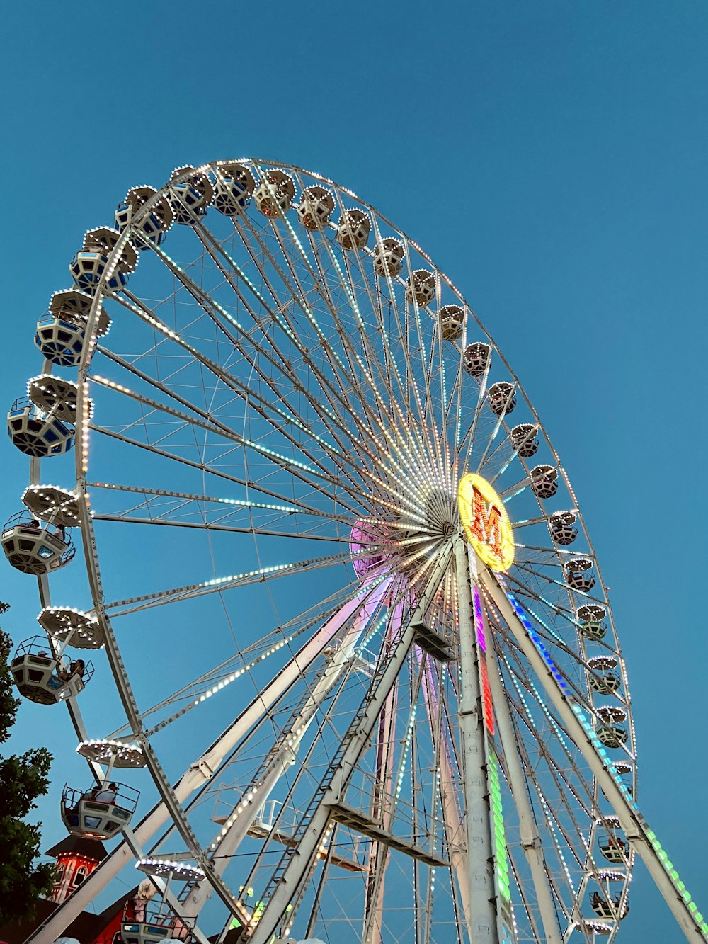 white and yellow ferris wheel under blue sky during daytime