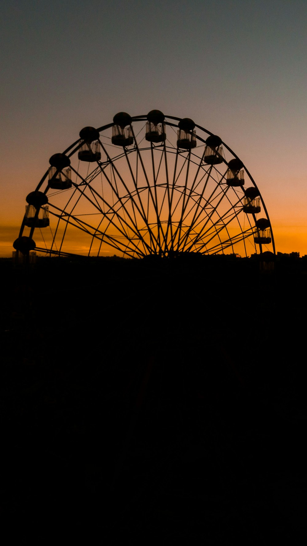 silhouette of ferris wheel during sunset