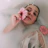 Close-up of a flower bath with vibrant petals floating in warm water, softly lit by candlelight.