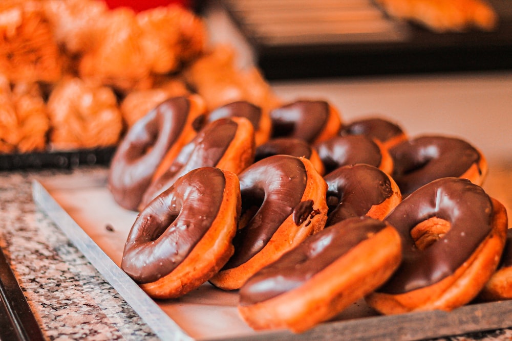 brown and white doughnuts on white paper