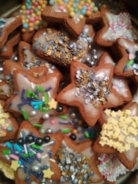 Delicate sugar cookies decorated with colorful icing and sprinkles.