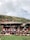 Group of women and children participating in a cultural workshop in a rural Andean village.