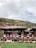 Group of women and children participating in a cultural workshop in a rural Andean village.