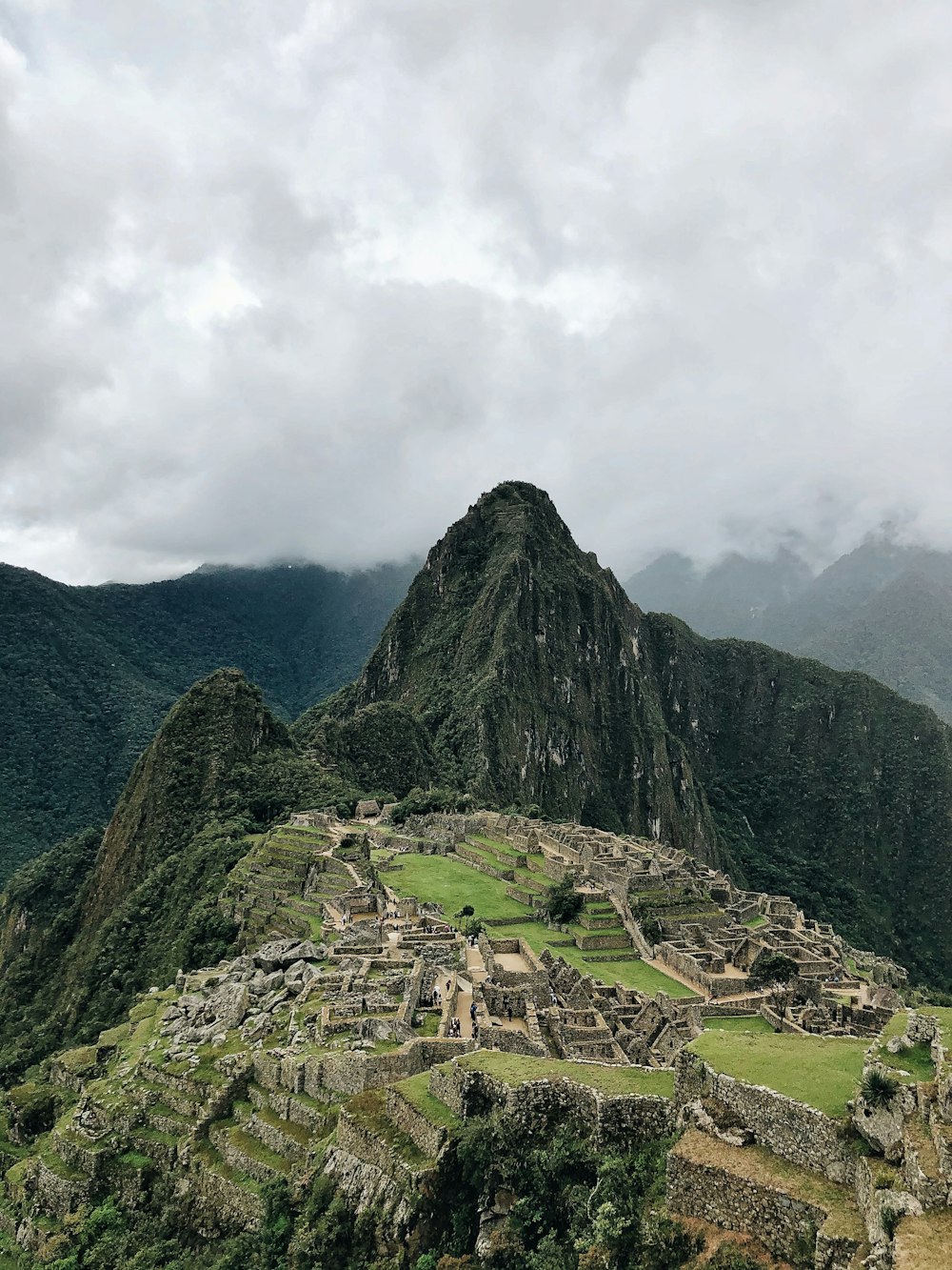 green and black mountain under white clouds during daytime