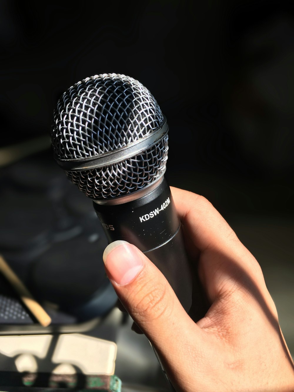 person holding black and silver microphone
