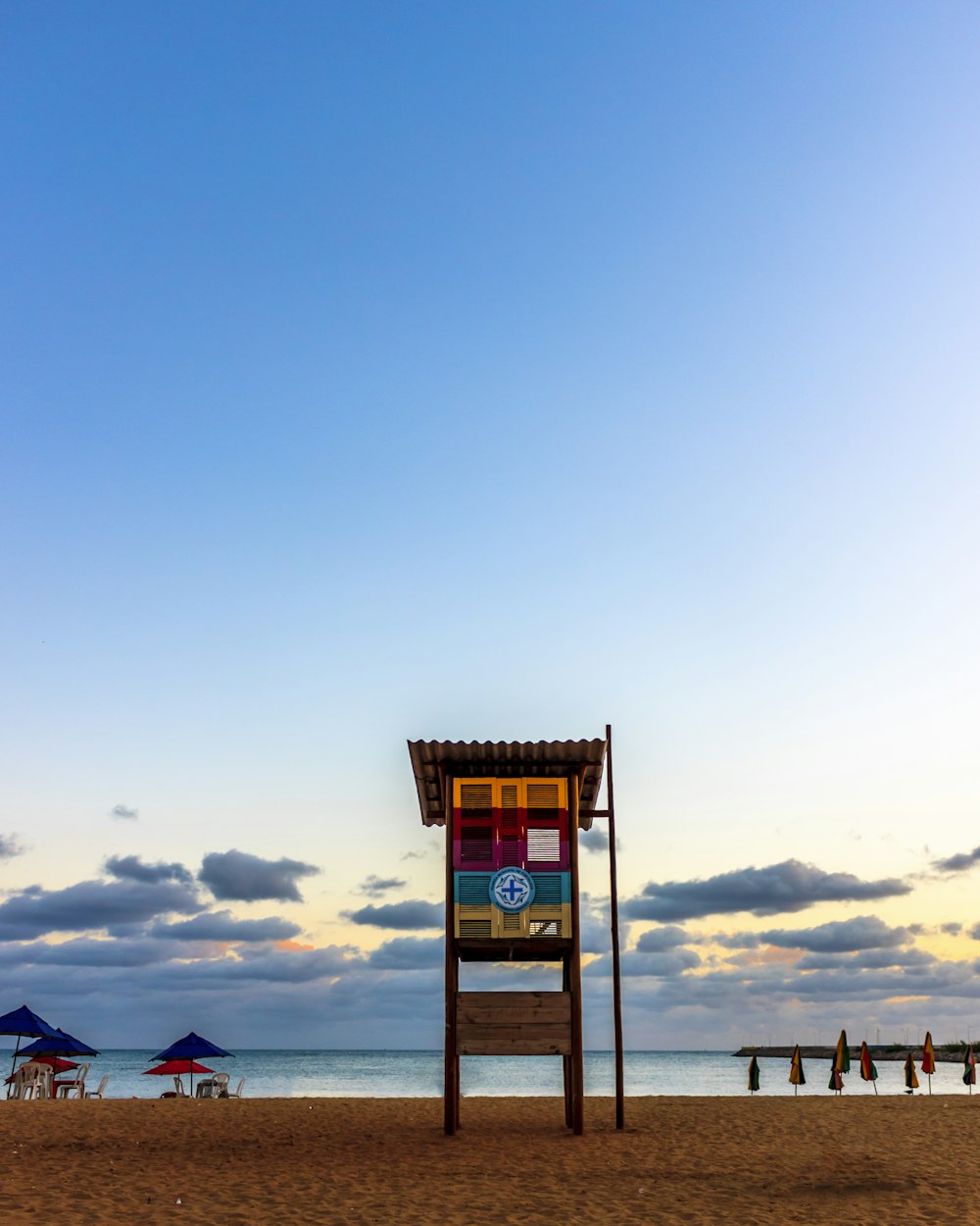 brown wooden lifeguard tower on beach during daytime