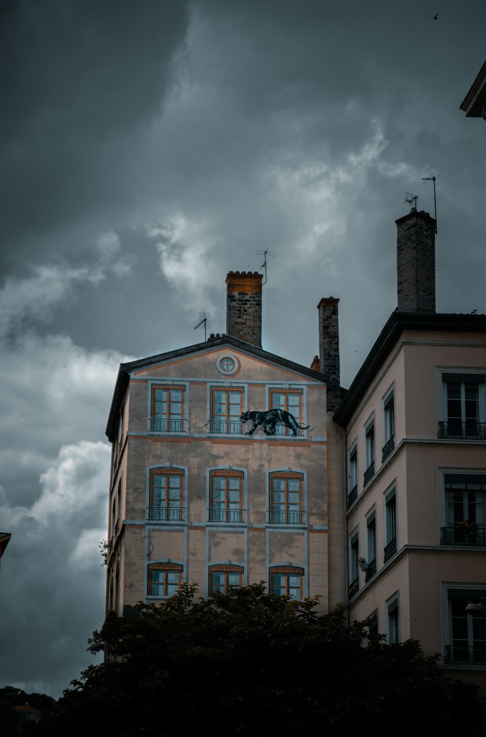 brown and white concrete building under cloudy sky during daytime