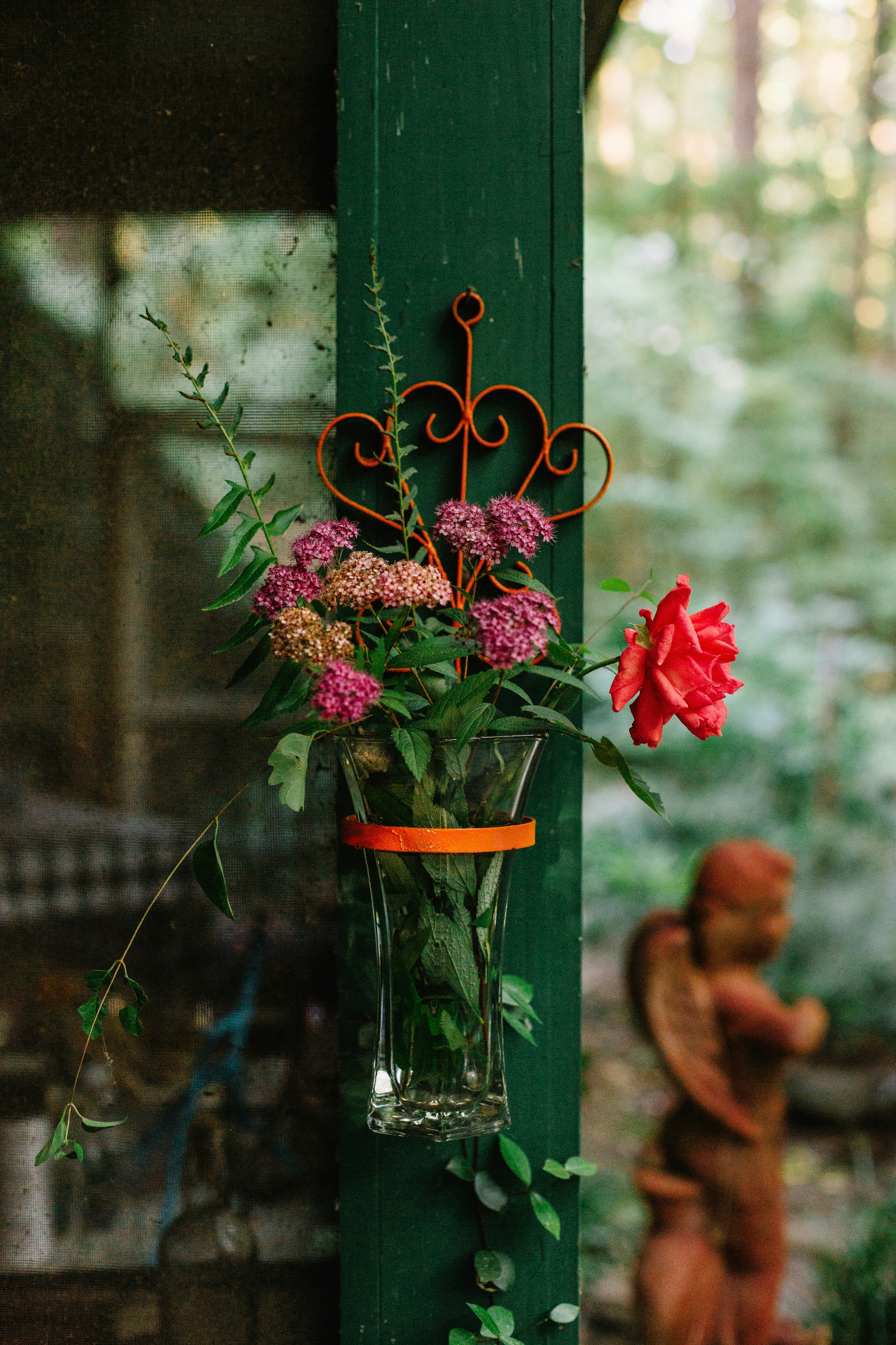 red flowers in clear glass vase