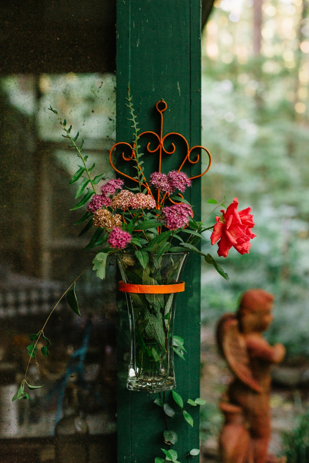 red flowers in clear glass vase