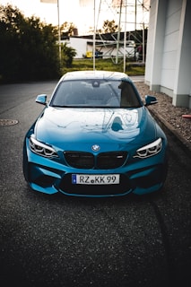 blue bmw m 3 parked on parking lot during daytime