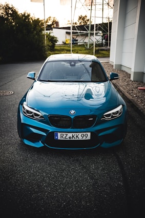 blue bmw m 3 parked on parking lot during daytime