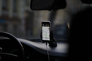 black iphone 4 on car seat
